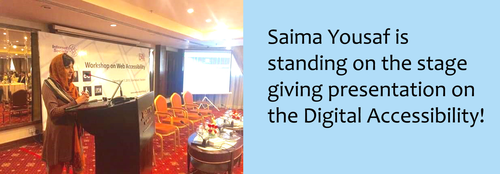 Saima Yousaf is standing on the stage giving presentation on the digital accessibility
